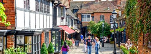 Visitors walking on a cobblestone street at the historic retail and residential property